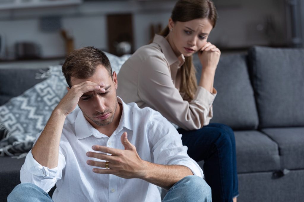 Couple with sad expressions during difficult conversation