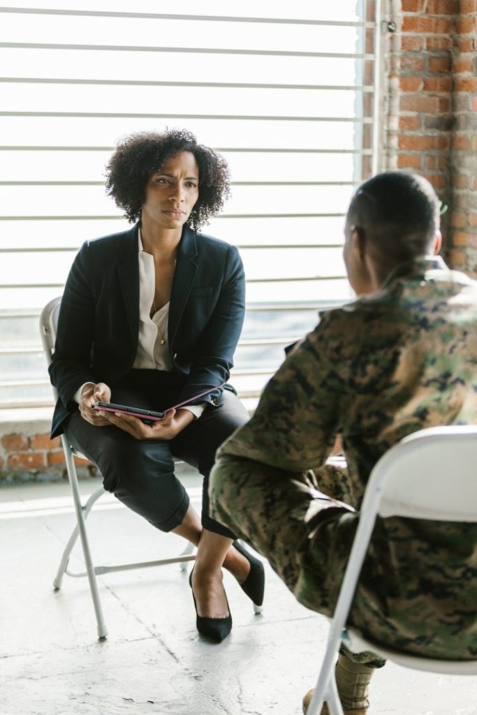 Therapist listening to a soldier in uniform