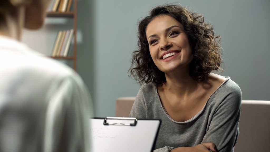 Smiling woman in later stages of IFS (Internal Family Systems) therapy
