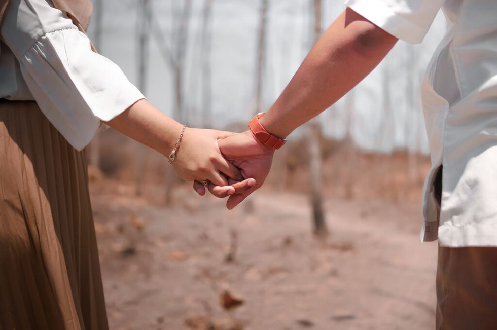 Couple holding hands to symbolize reconnection via therapy